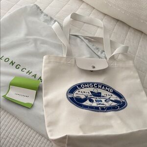 Longchamp White Tote with Blue Emblem